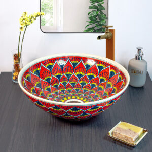 Handmade ceramic basin with a bold red and gold lotus-inspired design, crafted using traditional Thai techniques.