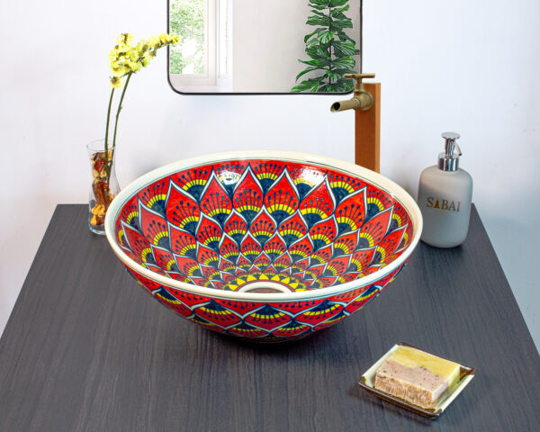 Handmade ceramic basin with a bold red and gold lotus-inspired design, crafted using traditional Thai techniques.