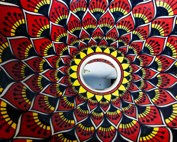 Close-up of the detailed lotus design on a handmade ceramic basin, showcasing fine artistry.