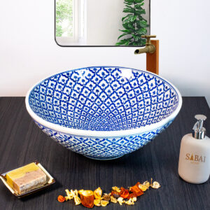 Hand-painted ceramic sink with an intricate blue mosaic pattern, inspired by traditional Thai craftsmanship.