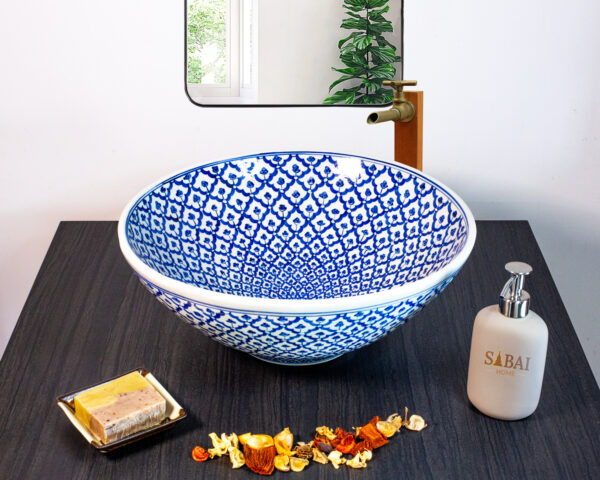Hand-painted ceramic sink with an intricate blue mosaic pattern, inspired by traditional Thai craftsmanship.