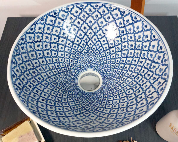 Overhead view of a blue mosaic ceramic sink showcasing detailed geometric patterns.