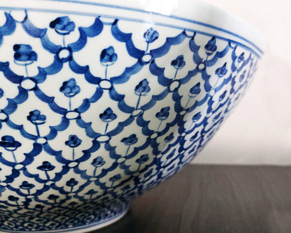 Side profile of the blue mosaic ceramic sink, showing its elegant curved shape.