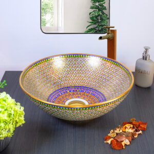Geometric-patterned ceramic sink with gold and blue accents, inspired by Thai latticework.