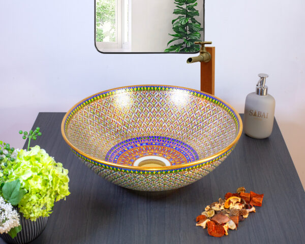 Geometric-patterned ceramic sink with gold and blue accents, inspired by Thai latticework.