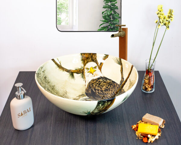 Unique ceramic basin depicting a detailed eagle in a misty forest, adding a bold touch to your space.