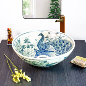 Thai-inspired ceramic sink featuring a majestic blue peacock design, showcasing exquisite craftsmanship.