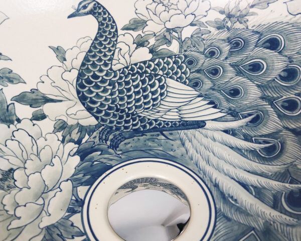 Close-up of Elegant Peacock sink, showing fine details of the peacock’s feathers.