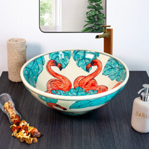 Vibrant ceramic sink with a hand-painted pink flamingo and teal accents for a tropical and artistic vibe.