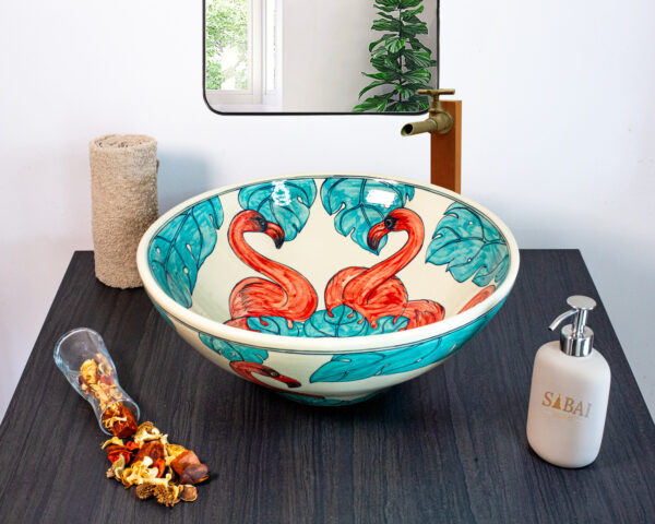 Vibrant ceramic sink with a hand-painted pink flamingo and teal accents for a tropical and artistic vibe.