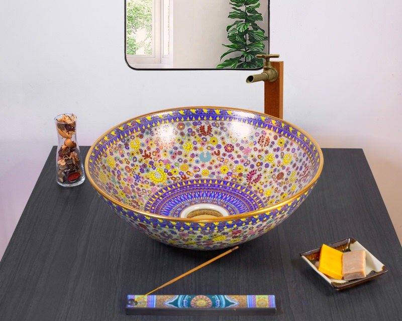 Exquisite ceramic sink with delicate golden floral patterns and royal blue accents.