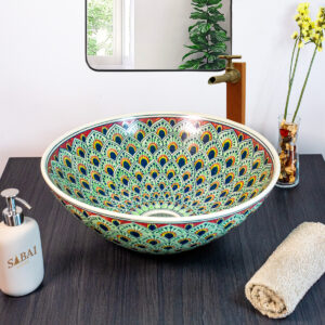 Luxurious ceramic sink adorned with detailed peacock feather patterns in rich blue and gold hues.