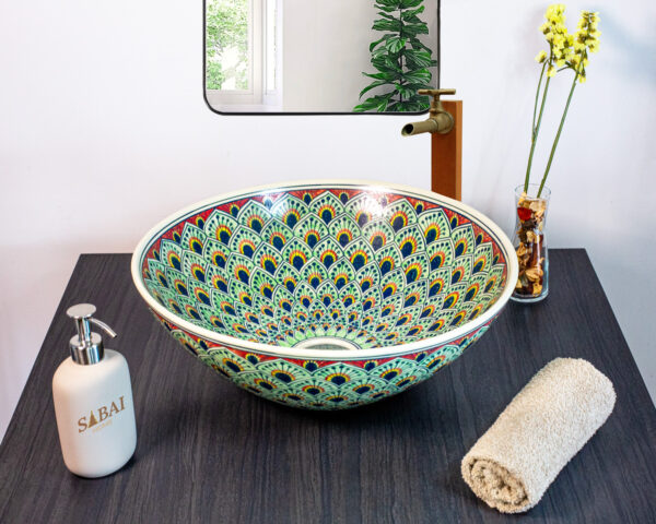 Luxurious ceramic sink adorned with detailed peacock feather patterns in rich blue and gold hues.