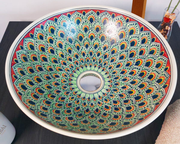 Overhead shot of Majestic Plume ceramic sink, displaying its vibrant peacock feather design.