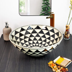 Bold black-and-white geometric ceramic sink with an optical illusion pattern for a modern touch.