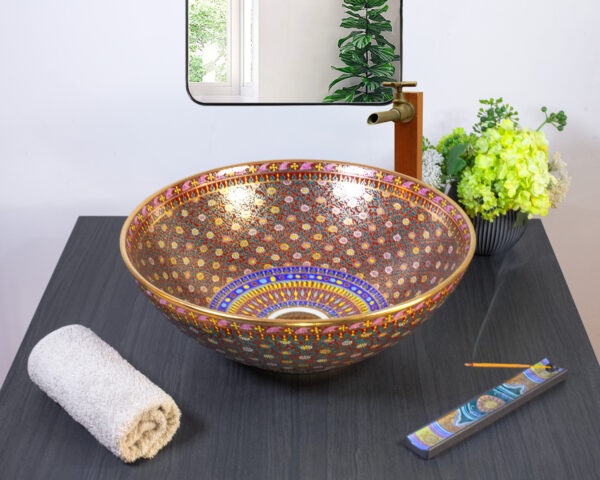 Elegant ceramic sink featuring rich red and gold geometric patterns for a regal look.