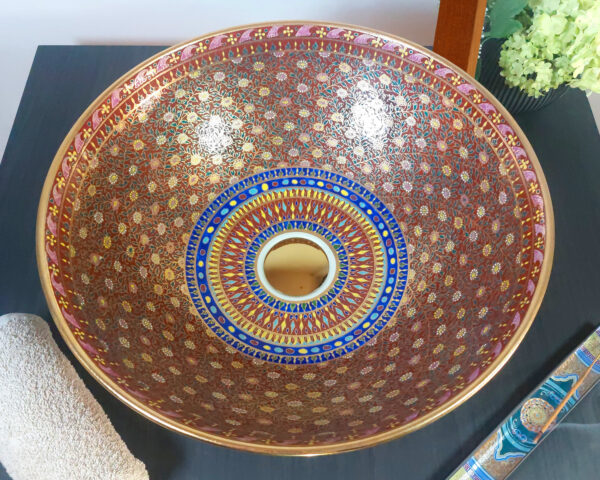 Overhead shot of Royal Garnet sink, showcasing its symmetrical hand-painted motifs.