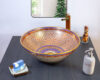Traditional Thai ceramic sink with a mesmerizing red and gold geometric star pattern.