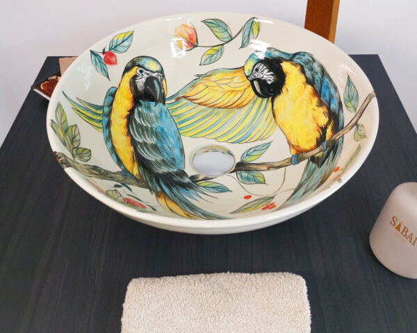 Top-down shot of Tropical Parrots ceramic sink, featuring hand-painted birds.