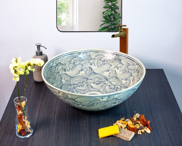 Elegant ceramic basin featuring soft swirling patterns reminiscent of flowing water for a serene bathroom ambiance.