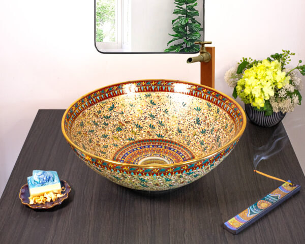 Front view of Celestial Mosaic ceramic basin with intricate floral and gold details.