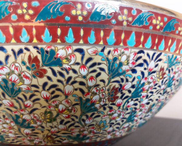 Side profile of basin featuring golden accents and curved form.