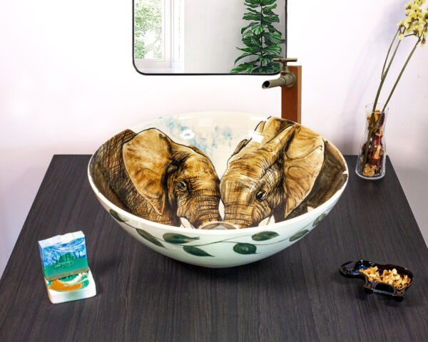 Front view of Elephant Embrace sink featuring two facing elephants.