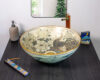 Front view of ceramic basin with gold-accented peacock and floral art