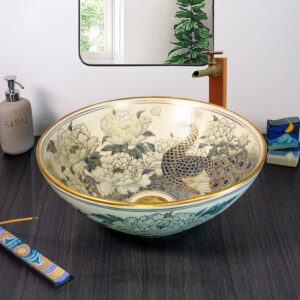 Front view of ceramic basin with gold-accented peacock and floral art