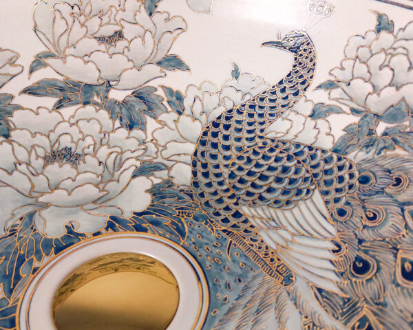 Close-up of peacock feathers and 12% gold paint inside basin