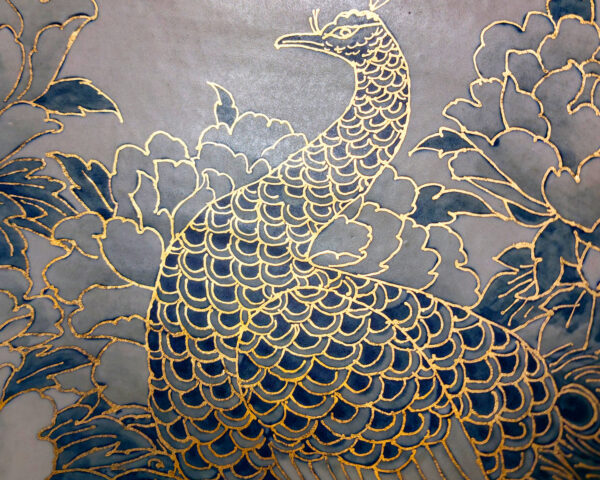 Detail view of 12% gold paint accents on peacock feathers in ceramic basin