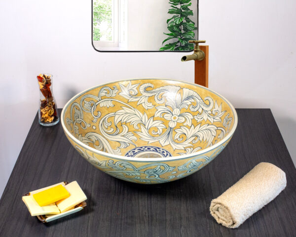 Front look at ceramic sink with golden vine pattern