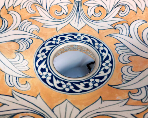 Detail of golden vine pattern inside ceramic bowl