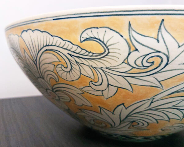 Side view of elegant gold and cream ceramic basin