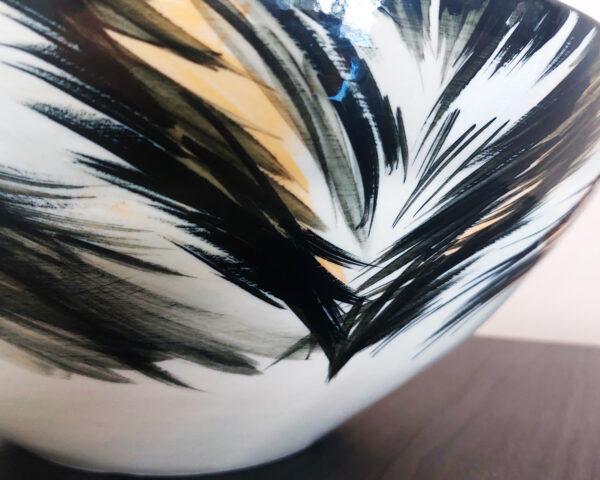 Side profile showing the shape and bold artwork of the basin.