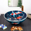 Front view of koi fish ceramic basin with blue water motif