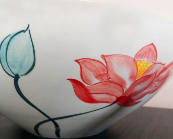 Side profile of the bowl showing curved shape and floral accents.
