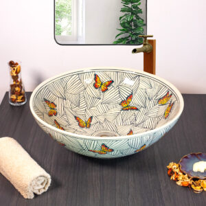 Front view of Monarch Canopy ceramic sink featuring butterflies and tropical leaves.