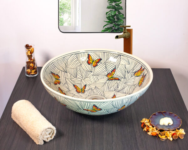 Front view of Monarch Canopy ceramic sink featuring butterflies and tropical leaves.