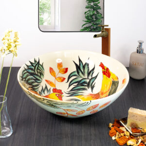 Ceramic sink with rooster design seen from front angle