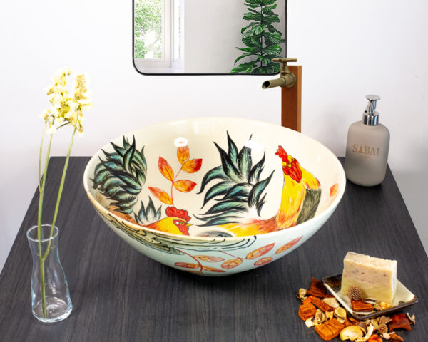 Ceramic sink with rooster design seen from front angle