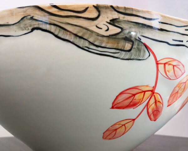 Side view showing rooster artwork and bowl shape