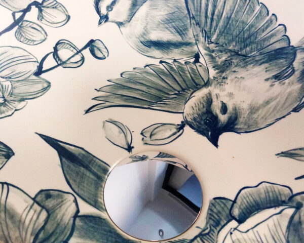 Close-up of hand painted orchid design in soft blue hues.