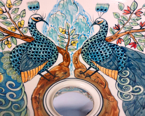 Detail of peacock feathers and florals inside basin