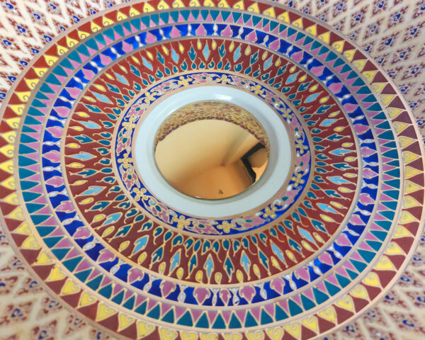 Close-up of golden pattern work with matte and glossy textures.