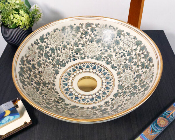 Top view of floral motif basin with gold detailing