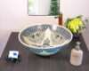 Handcrafted ceramic basin with traditional Thai mythical creatures on the front view