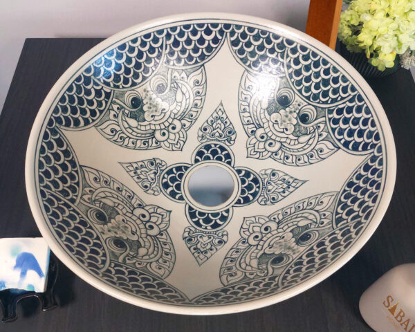 Overhead view of ceramic sink featuring Thai-style mythical creatures and intricate patterns