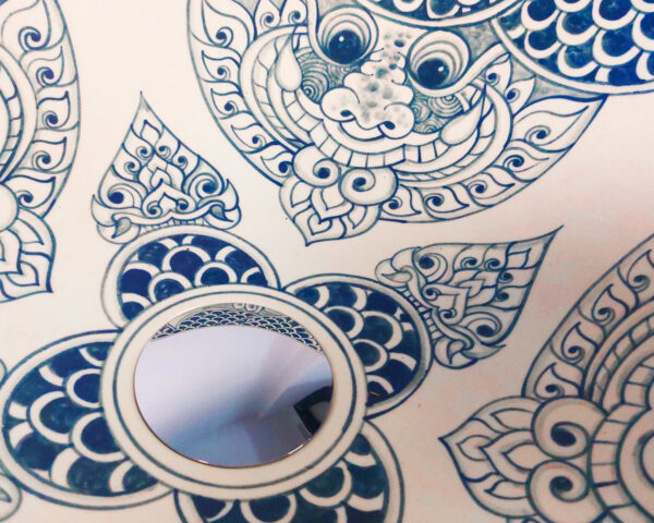 Detailed close-up showing Singha- or Kinnari-inspired motifs on the ceramic basin