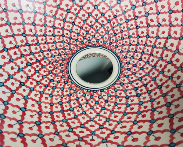 Close up of Crimson Weave hand painted ceramic basin, intricate Thai porcelain texture detail.